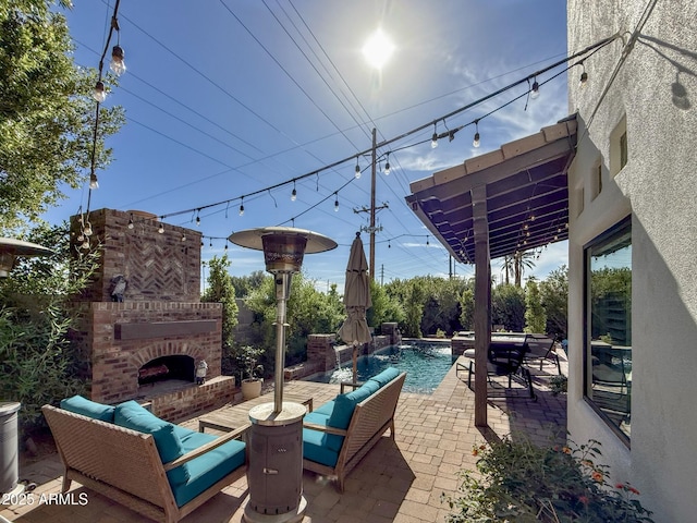 view of patio with an outdoor living space with a fireplace