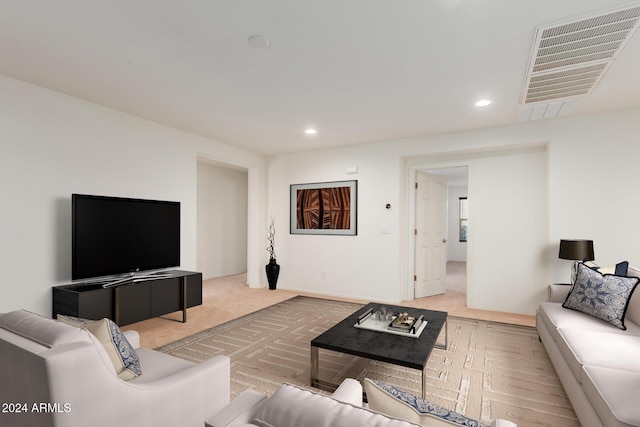 living room with recessed lighting and light colored carpet