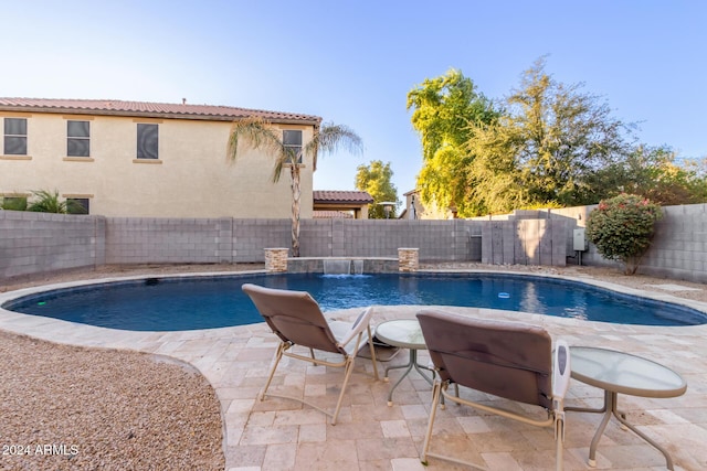 view of swimming pool featuring a fenced backyard and a patio area