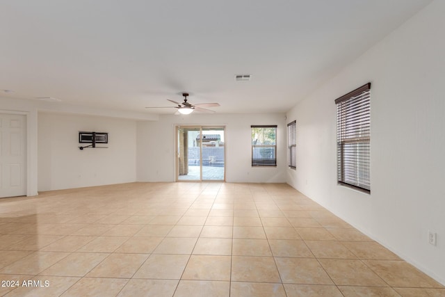 empty room featuring ceiling fan and light tile patterned floors