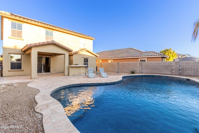 view of swimming pool with a fenced backyard and a patio