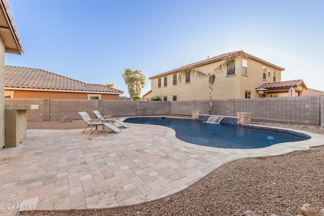 view of pool featuring a fenced backyard and a patio