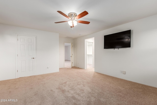unfurnished living room with ceiling fan and light colored carpet