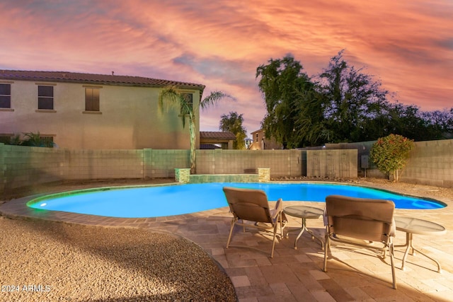 view of swimming pool with a fenced backyard and a patio