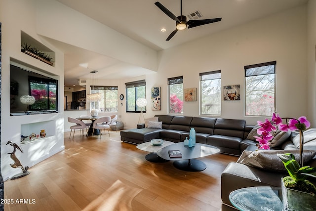 living room with ceiling fan and hardwood / wood-style floors