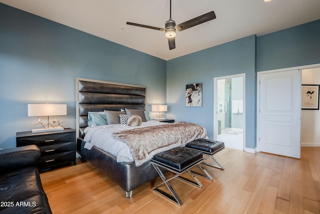 bedroom featuring ceiling fan, light hardwood / wood-style flooring, and ensuite bath