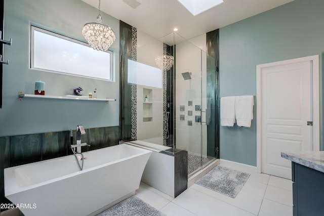 bathroom with vanity, tile patterned flooring, a notable chandelier, and shower with separate bathtub