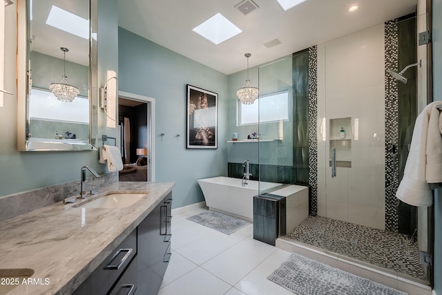 bathroom featuring a skylight, separate shower and tub, a notable chandelier, tile patterned floors, and vanity