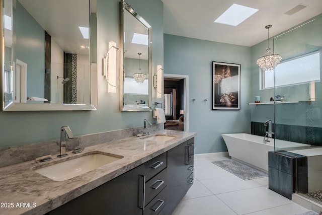 bathroom featuring an inviting chandelier, a skylight, tile patterned floors, shower with separate bathtub, and vanity