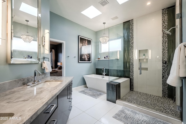 bathroom featuring vanity, tile patterned flooring, an inviting chandelier, and shower with separate bathtub