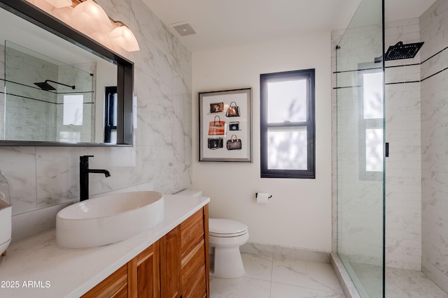 bathroom featuring toilet, vanity, tile walls, and tiled shower