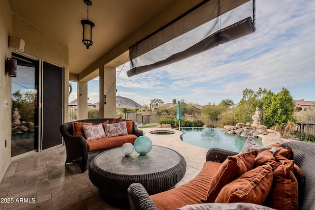 view of patio / terrace with pool water feature, a swimming pool with hot tub, a mountain view, and outdoor lounge area