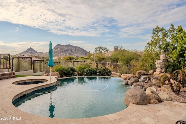 view of pool featuring a mountain view and an in ground hot tub