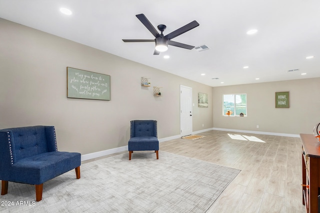 sitting room featuring light wood-type flooring and ceiling fan