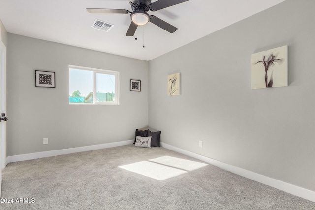 spare room featuring carpet floors and ceiling fan