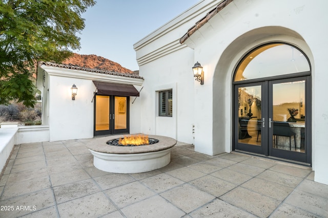 view of patio / terrace with french doors and a fire pit