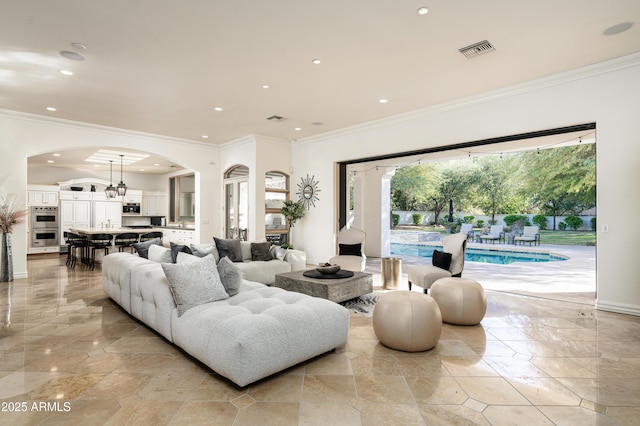 living room with a wealth of natural light and crown molding