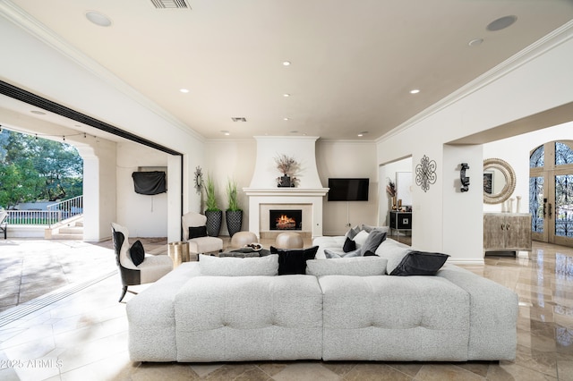 living room featuring a large fireplace, ornamental molding, and french doors