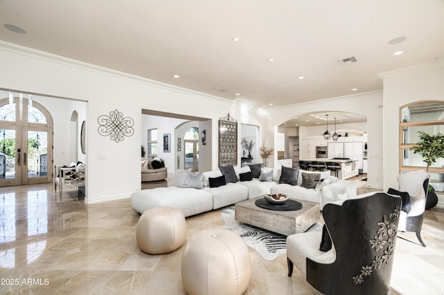 living room with french doors, an inviting chandelier, and crown molding