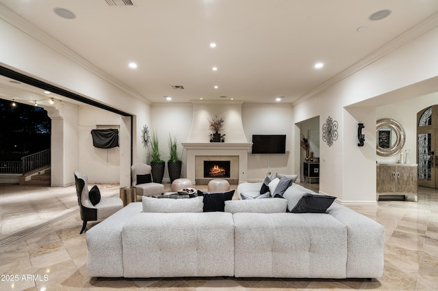 living room with a large fireplace and ornamental molding