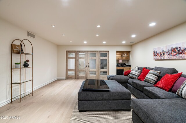 living room featuring light hardwood / wood-style floors and french doors