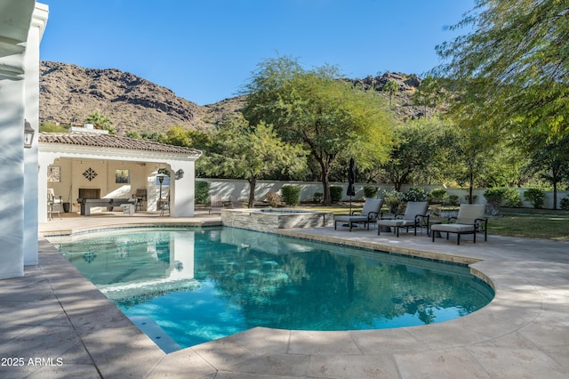 view of swimming pool with a mountain view, a patio, and an in ground hot tub