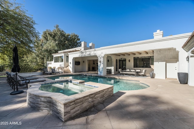 view of swimming pool featuring an in ground hot tub and a patio