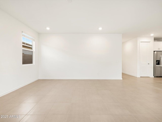 spare room featuring baseboards and recessed lighting