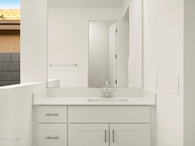 ensuite bathroom with connected bathroom and vanity