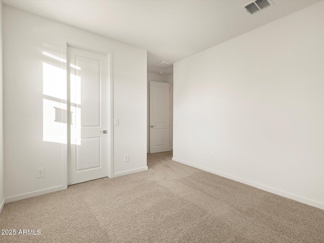 unfurnished bedroom with baseboards, visible vents, and light colored carpet