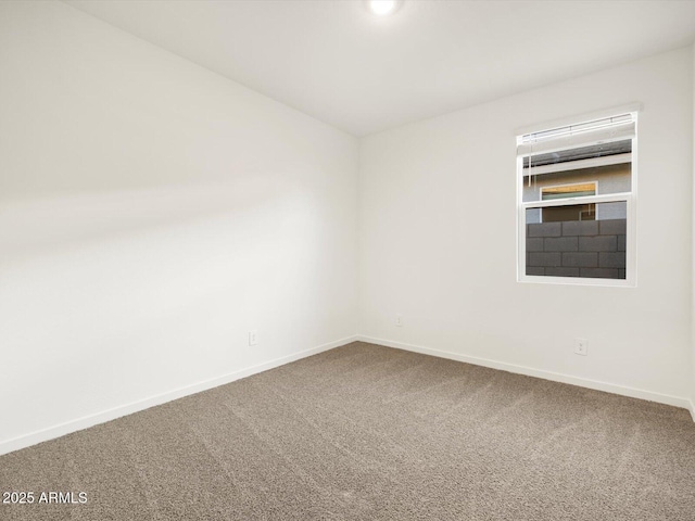 carpeted empty room with baseboards