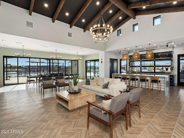 living area featuring high vaulted ceiling, beam ceiling, visible vents, and a notable chandelier