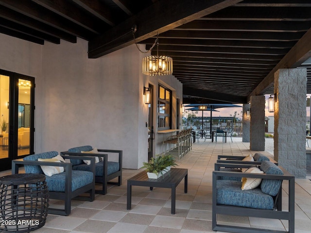 patio terrace at dusk with outdoor dining space and an outdoor living space