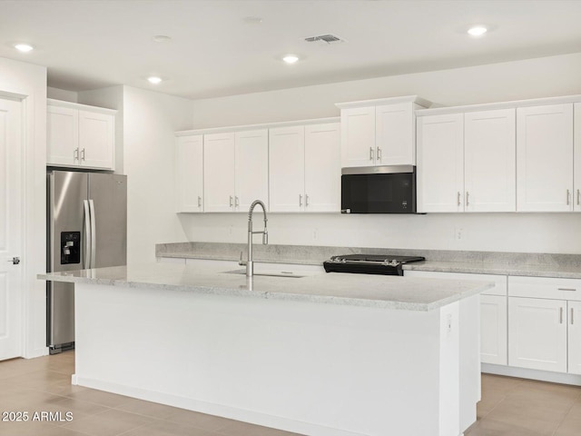 kitchen featuring an island with sink, black range with electric stovetop, white cabinetry, stainless steel refrigerator with ice dispenser, and a sink