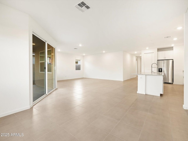 interior space with baseboards, light tile patterned flooring, visible vents, and recessed lighting