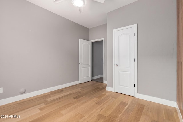 unfurnished bedroom featuring a ceiling fan, baseboards, and light wood finished floors