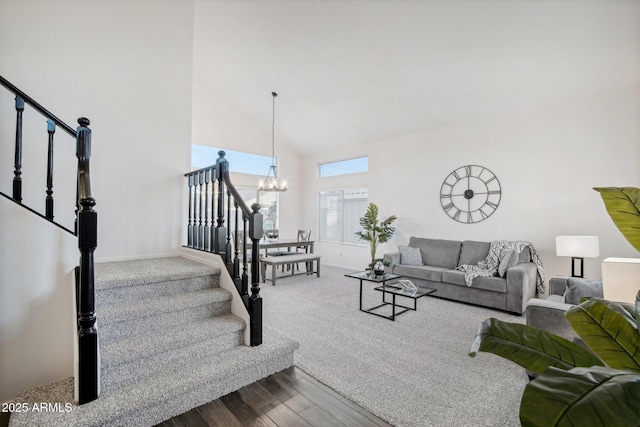 living room with hardwood / wood-style floors, a high ceiling, and a chandelier