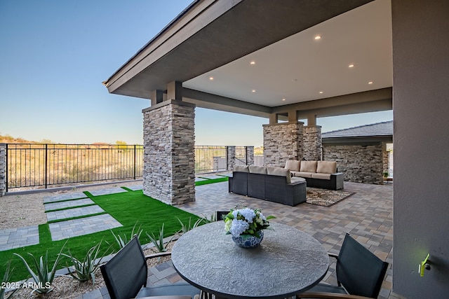 view of patio with an outdoor living space, outdoor dining space, and fence