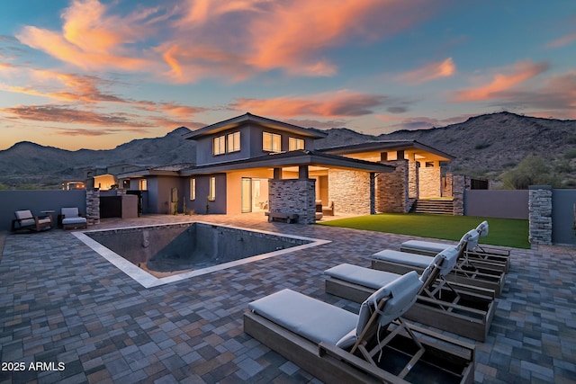 view of pool featuring a mountain view, a patio, and fence private yard