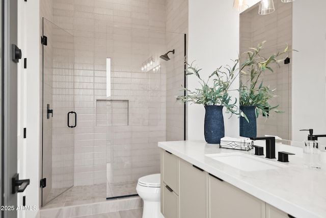 full bathroom with vanity, toilet, and a stall shower