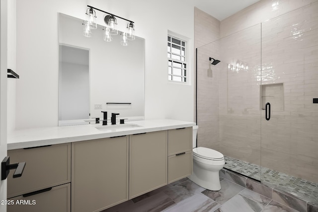 full bathroom with a shower stall, toilet, marble finish floor, and vanity