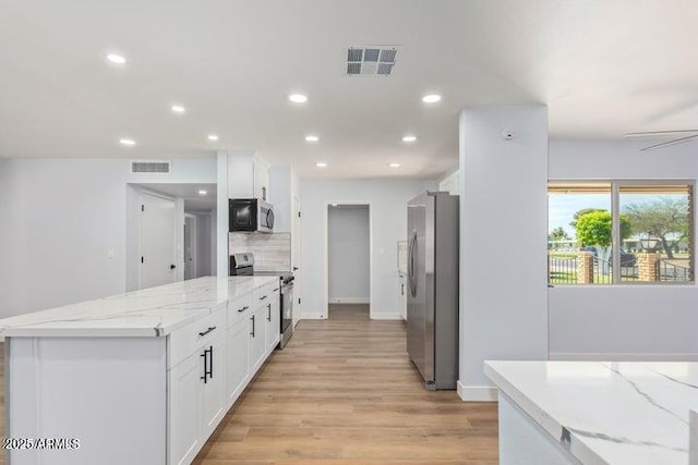 kitchen with visible vents, appliances with stainless steel finishes, and white cabinetry