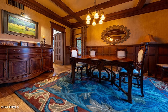 dining room featuring coffered ceiling, beamed ceiling, light hardwood / wood-style flooring, ornamental molding, and a notable chandelier