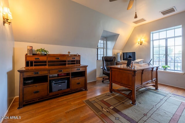 home office featuring ceiling fan, lofted ceiling, and hardwood / wood-style floors