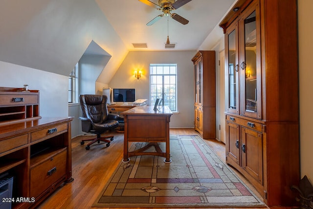 office featuring ceiling fan, vaulted ceiling, and light hardwood / wood-style flooring