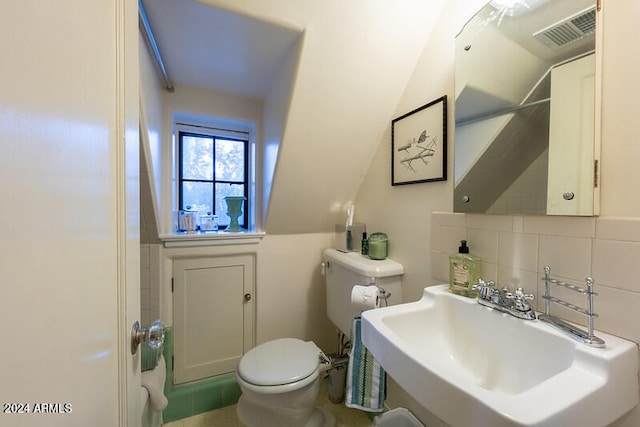 bathroom with sink, decorative backsplash, toilet, and tile patterned flooring