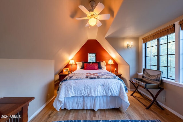 bedroom featuring vaulted ceiling, wood-type flooring, and ceiling fan