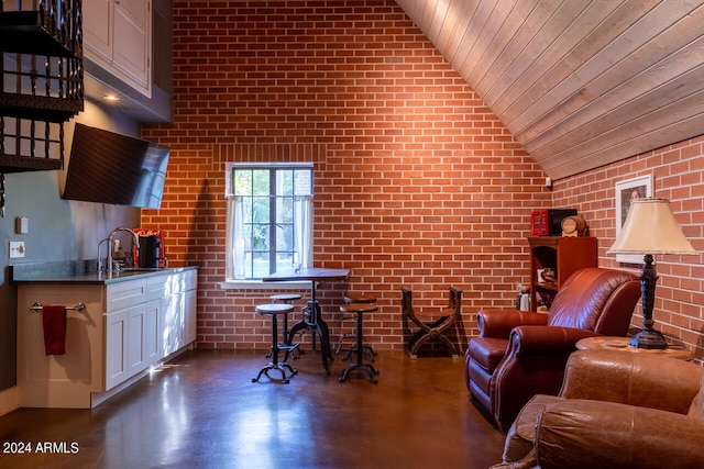 living room with sink, wood ceiling, lofted ceiling, dark wood-type flooring, and brick wall