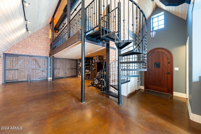 foyer entrance with high vaulted ceiling and rail lighting