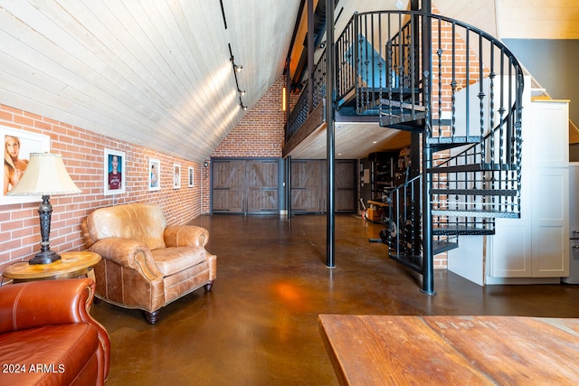 living area with brick wall and a towering ceiling